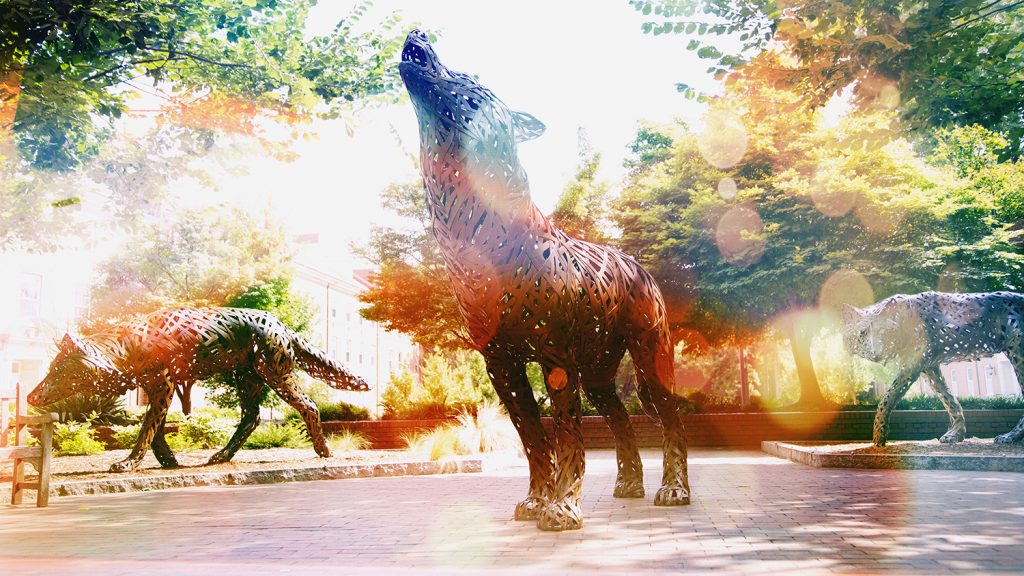 three wolf statues howling with bright filter