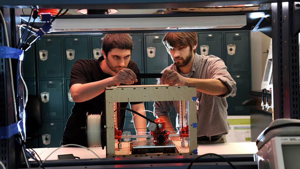 Kyle McKenzie and Corey Meade working on a 3D-printed audio bracelet