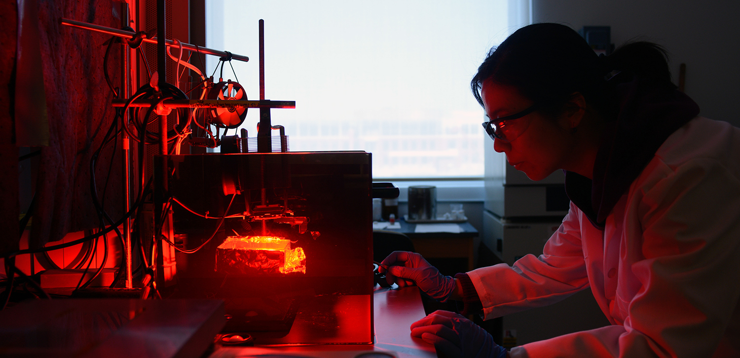 A graduate student at work in the lab of Michael Dickey in NC State's College of Engineering.