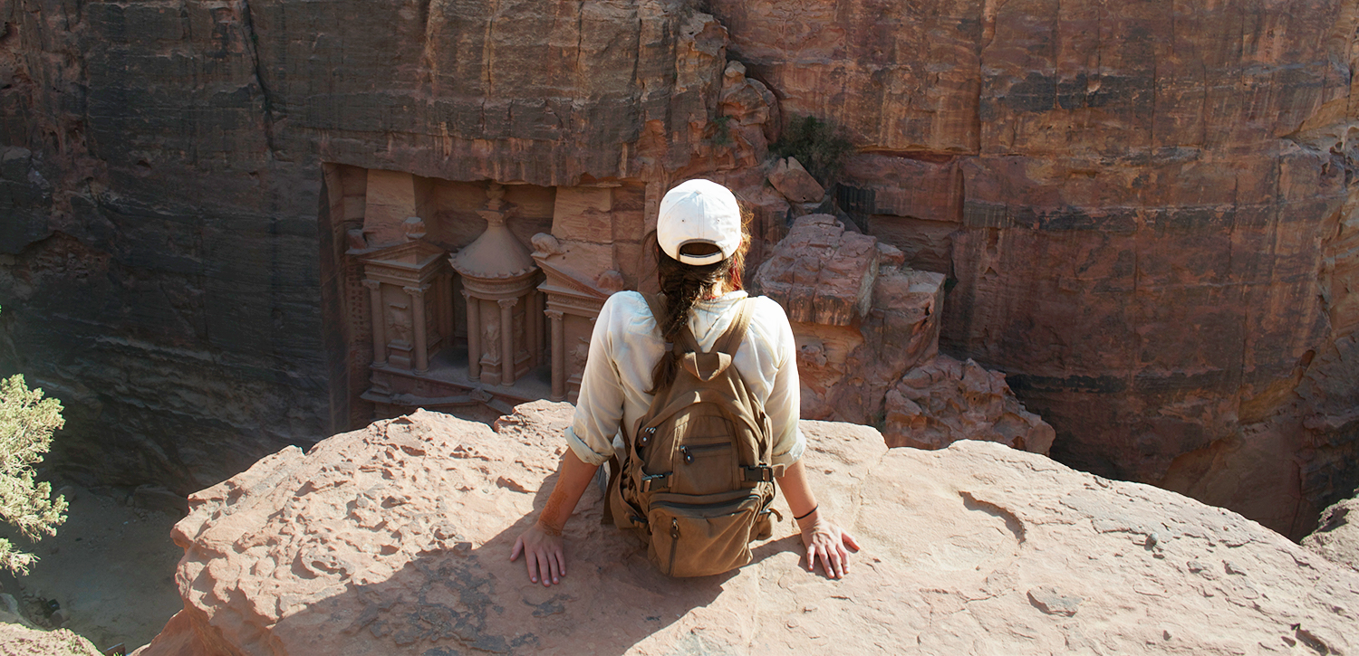 Jordan Karlis sitting at the edge of a canyon.