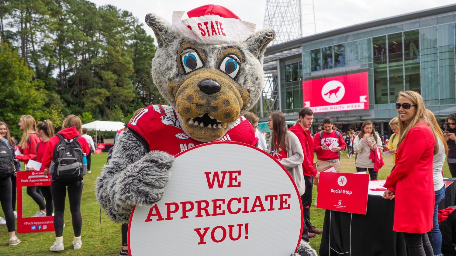 Mr Wuf holding up We Appreciate You sign during Pack Appreciation Day