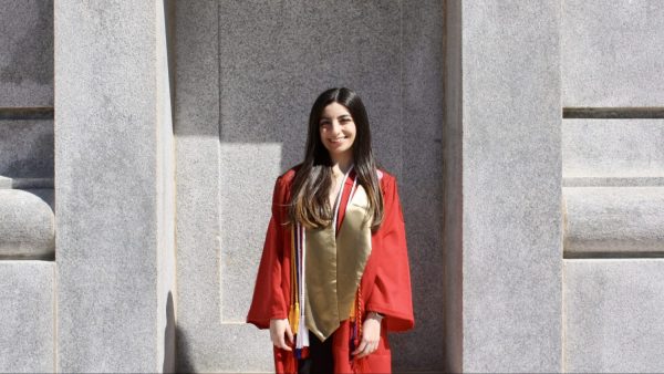 Loujain Al Samara in her graduation attire in front of the belltower