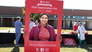 a CVM student poses in a Pack Appreciation Day selfie frame
