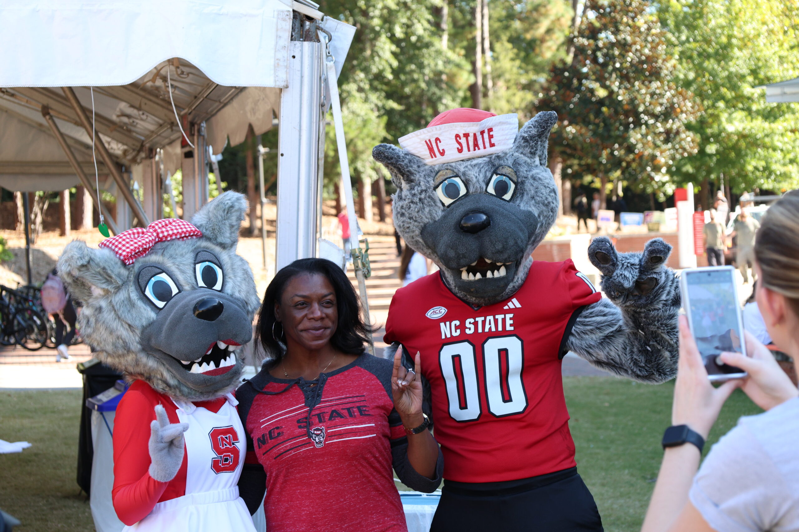 Mr. and Ms. Wuf posing with a student