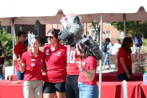 Mr. Wuf posing with volunteers.