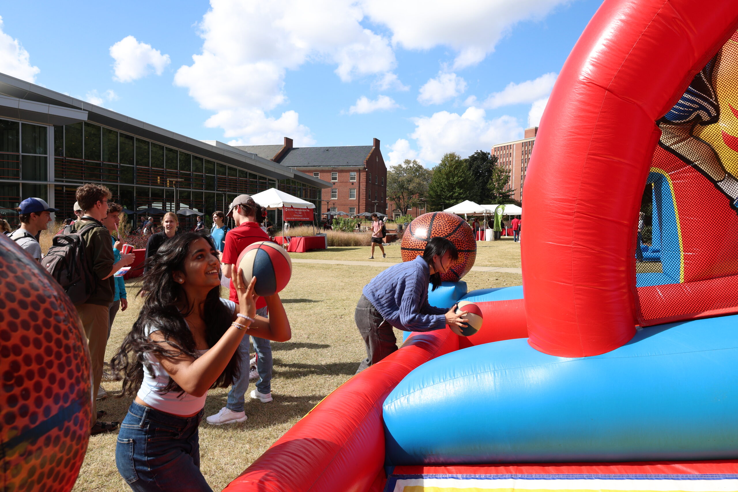 A student shooting an inflatable basketball. 