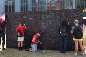 Students writing notes of appreciation a chalkboard.